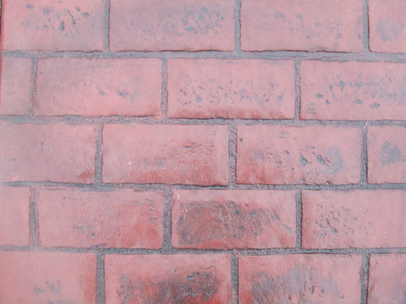 Closeup photo of a running bond brick concrete stamp.