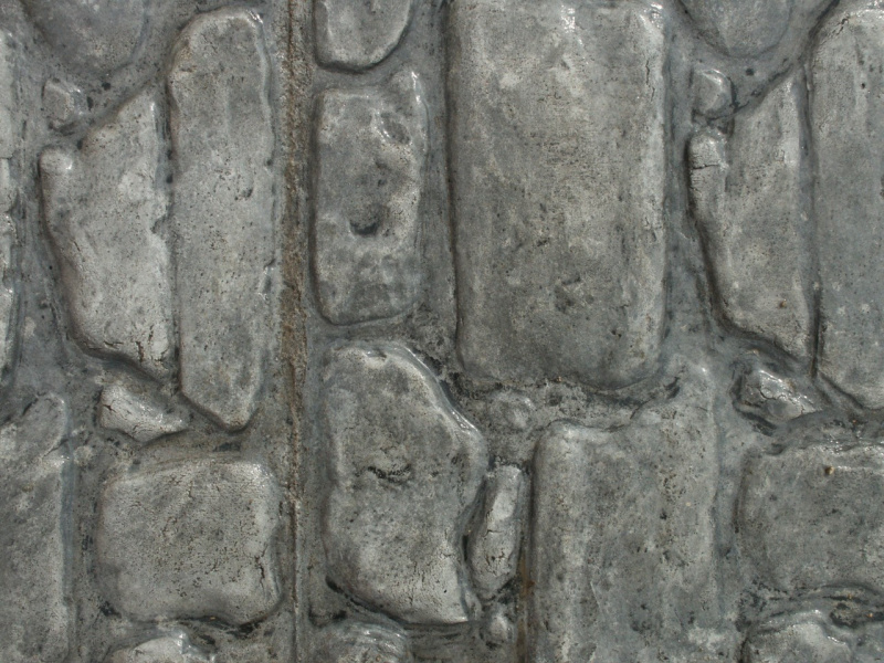 Closeup photo of a cobblestone concrete stamp.