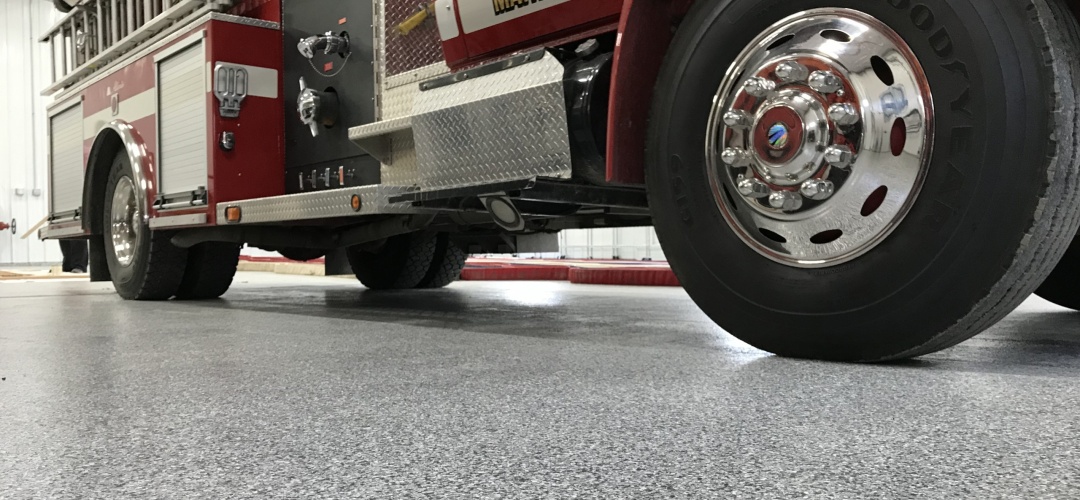 poly coated garage floor with firetruck parked atop