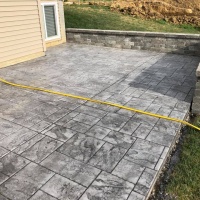 Ashlar Cut Stamped Patio With Retaining Wall