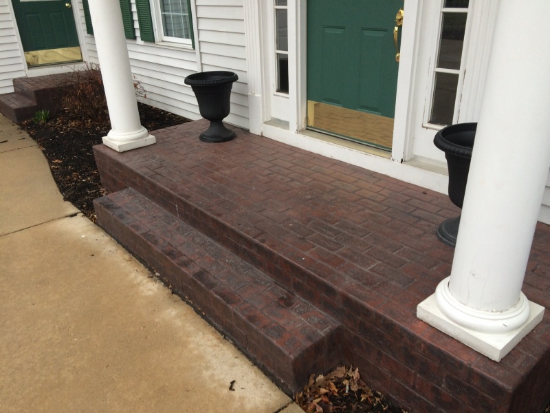 brick stamped porch with white pillars
