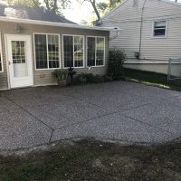 Exposed Aggregate Rear Patio Behind A House