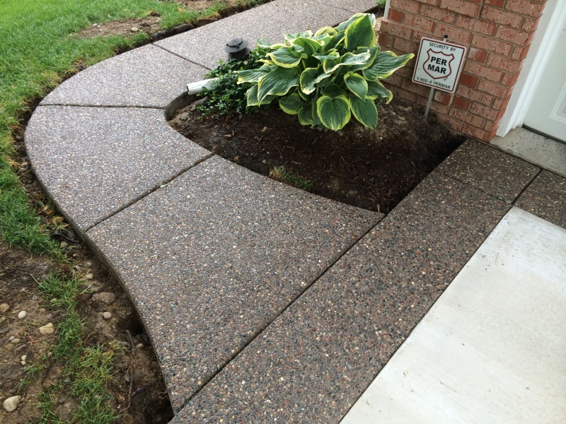 exposed aggregate walkway on side of home