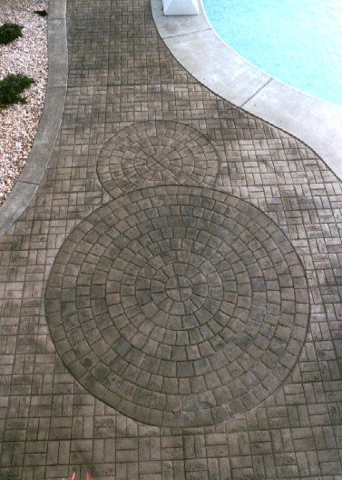 Radial Stone Stamped Decorative Concrete Near A Pool